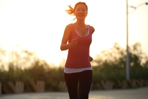 exercise and addiction recovery - woman runner on road - mountain laurel recovery center