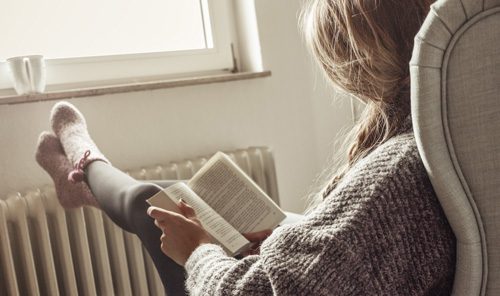8-Ways-to-Manage-Stress-in-Recovery - woman in sweater reading book