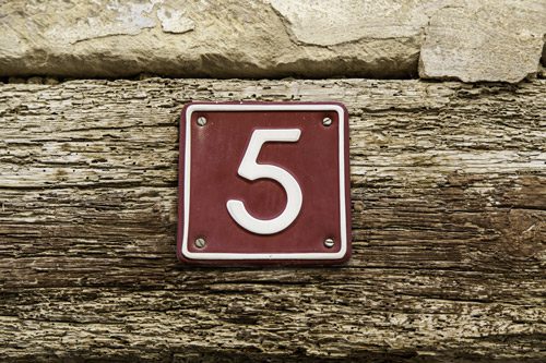 metal sign with number five affixed to a wooden board - stages of addiction